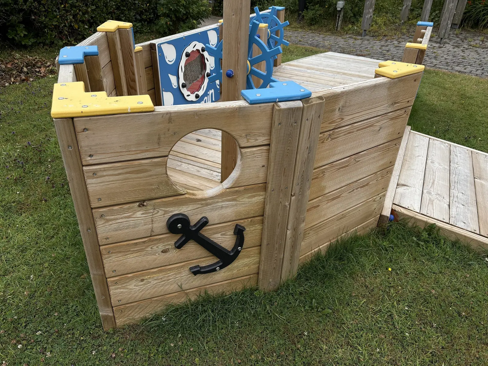 All Ability Tug Boat inclusive playground boat with accessible ramp and ship wheel panel