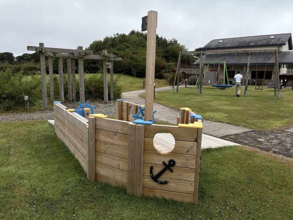 All Ability Tug Boat installed in landscaped playground setting with accessible entrance