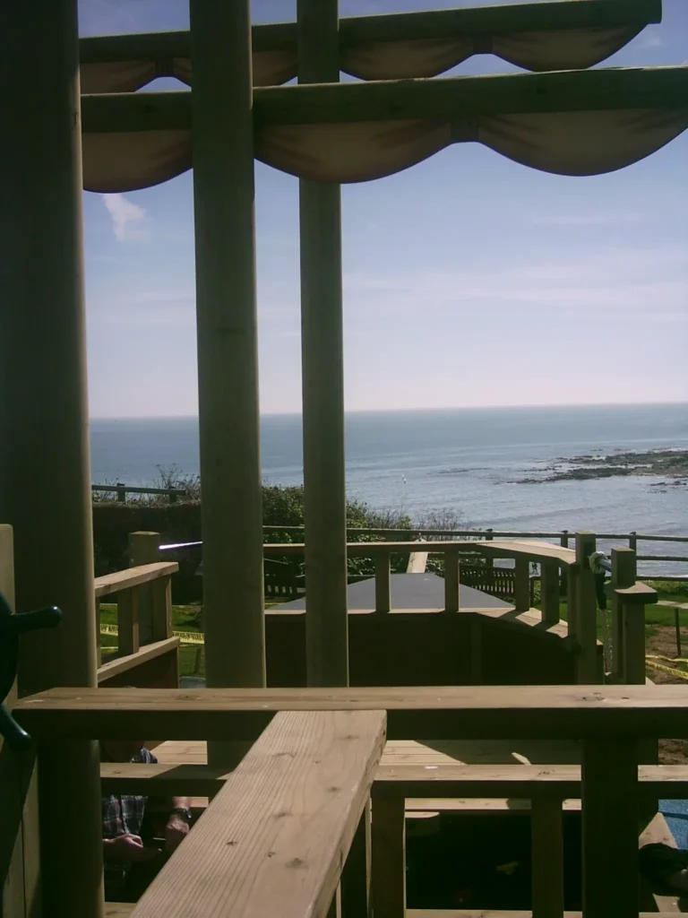 The view from the deck of The Coverack Queen outdoor play ship, looking out over a beautiful coastal scene.