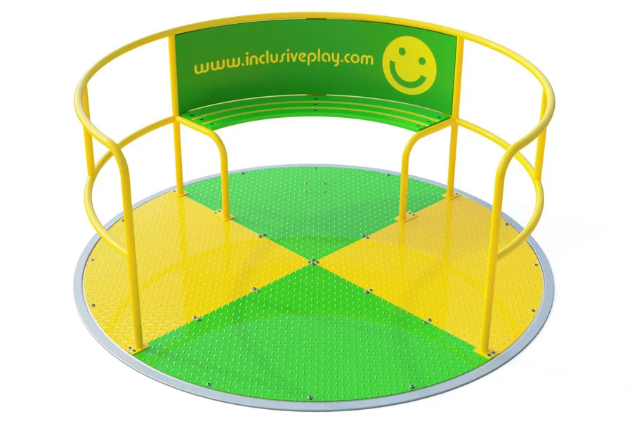 The Inclusive Wheelspin Roundabout in a playful yellow and green design, with a smiley face logo, showing its flush-to-surface, wheelchair-accessible platform.