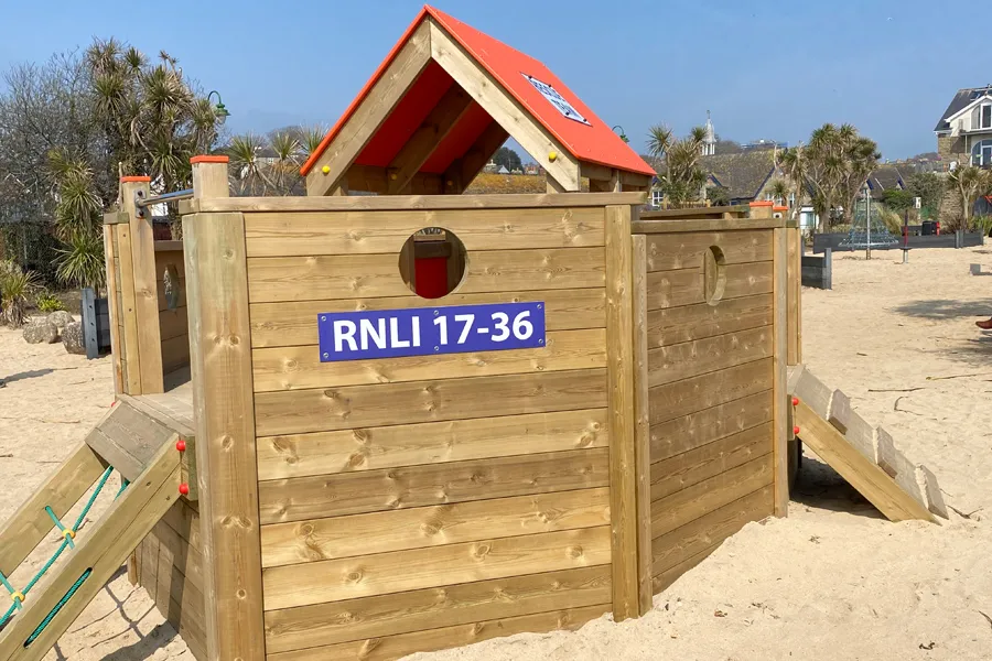 The entrance to the Lifeboat play equipment, showing the deck, steps, and a decorative lifebuoy.