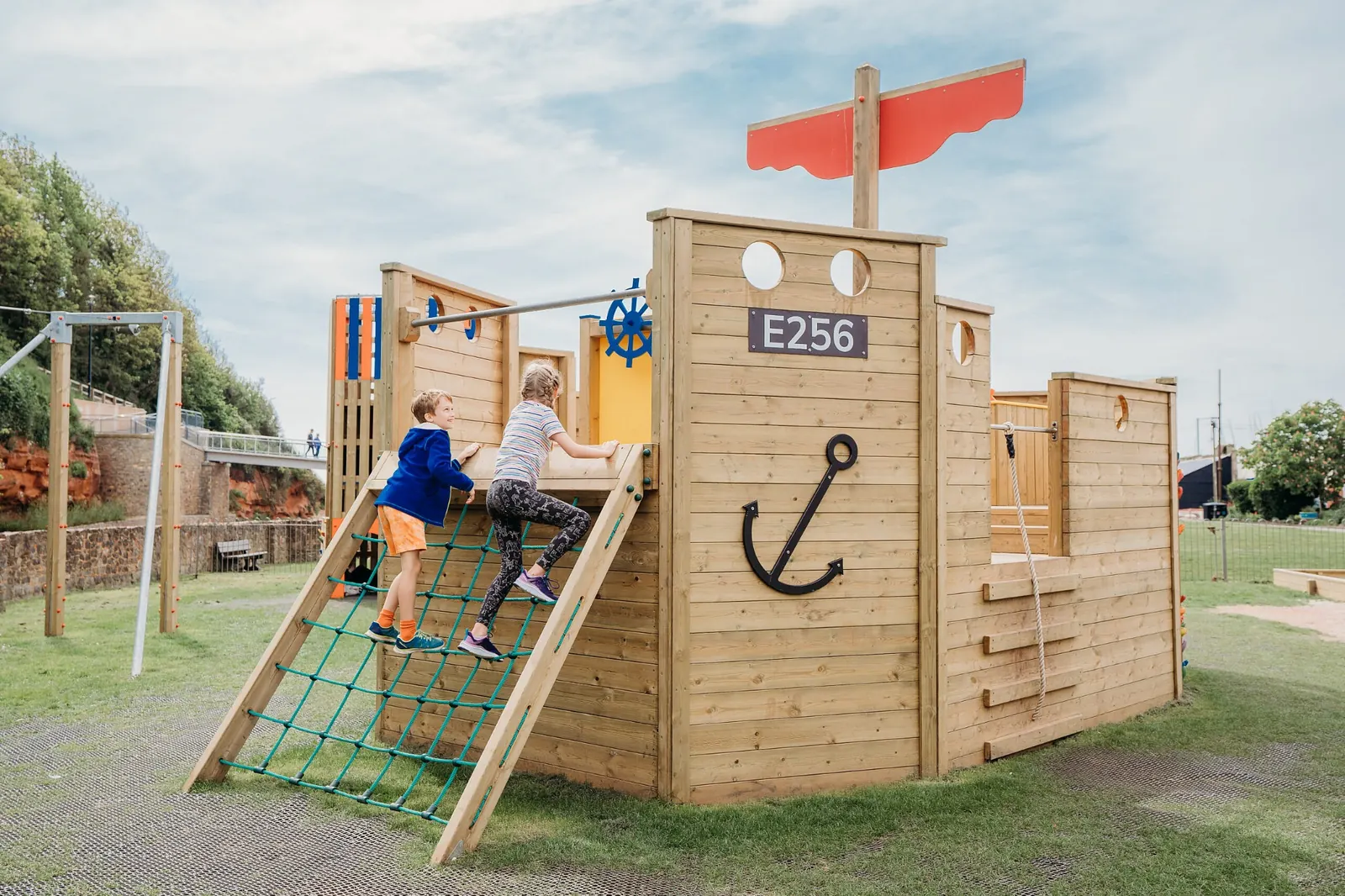 Children climbing wall on Martha D wooden playground boat