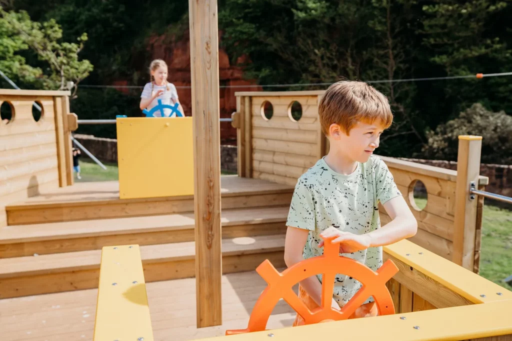Children playing on deck of Martha D wooden playground boat