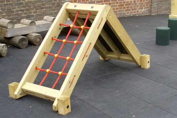 The Mini Ramp Net Climber outdoor play equipment, showing the red rope net side, installed on a black rubber tile surface in a school playground.