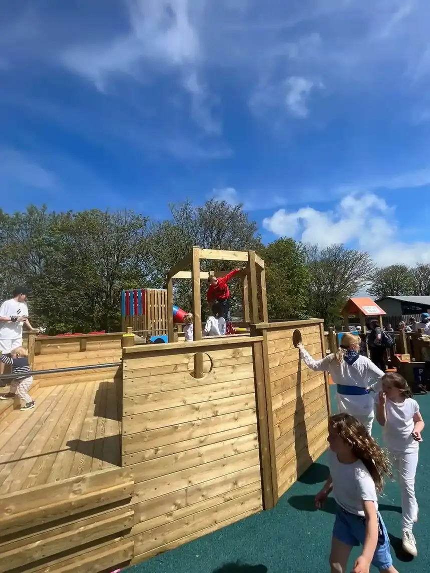 Children engaging in imaginative play on Padstow Trawler wooden playground ship