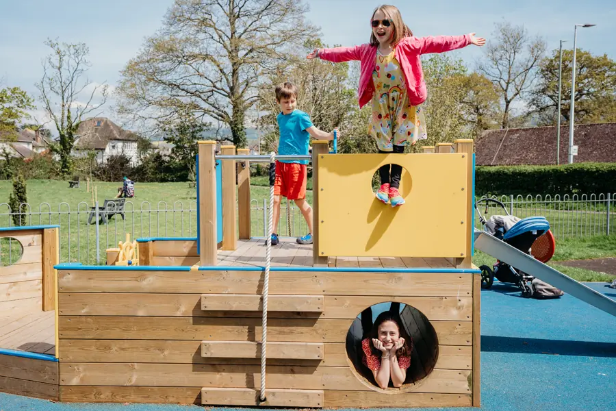 Children playing on St Eval Sailor timber playground ship structure