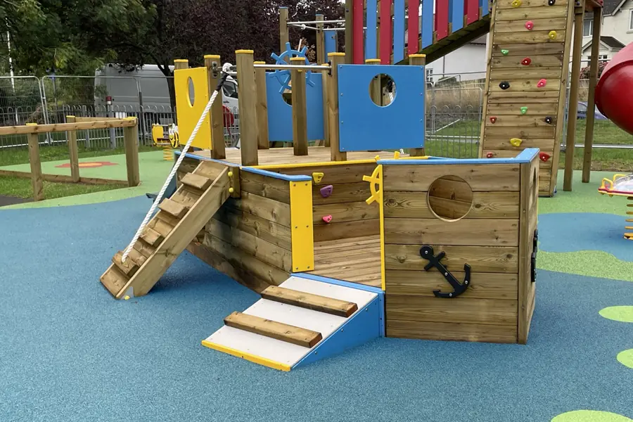 Side view of St Eval Sailor wooden playground boat with access steps