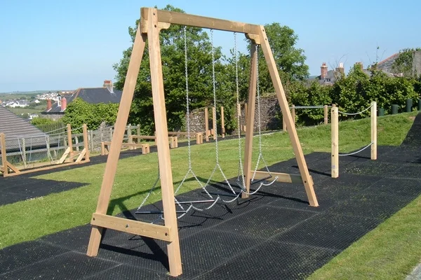 A wooden A-frame Swinging Steps outdoor play equipment with chain steps, set on a black rubber safety surface.