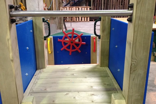 View from the deck of the Trenance Trawler outdoor play boat, looking at the ship's wheel.