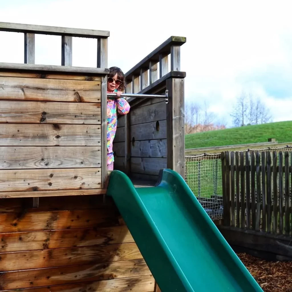 Timber playground ship with integrated slide for active outdoor play