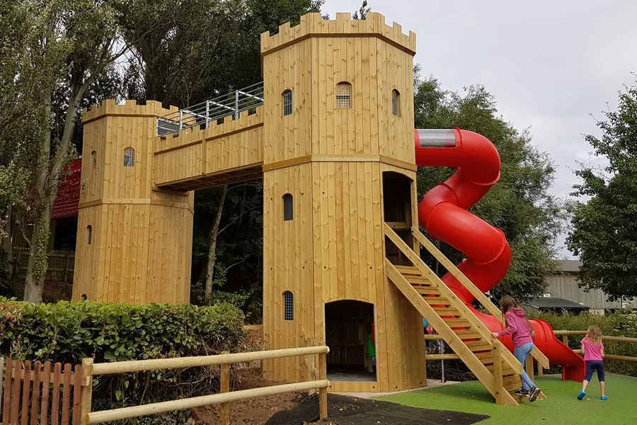 Large wooden play castle slide outdoor