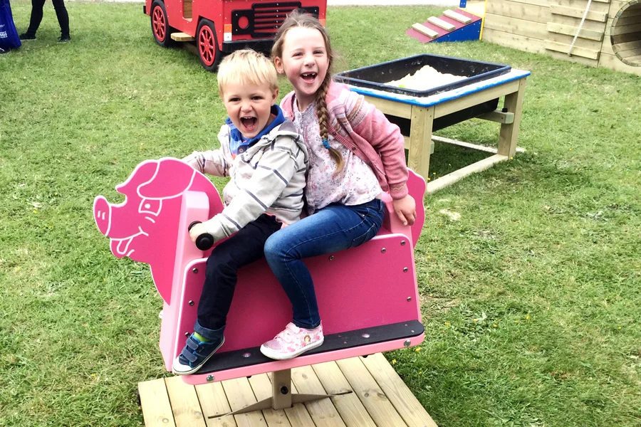 Pink pig children play rocker outdoor