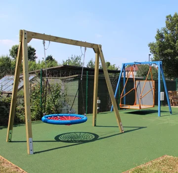 Timber special needs accessible swing in a wooden playground for inclusive outdoor play