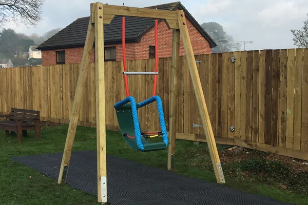 Timber special needs cradle swing designed for accessible playgrounds and outdoor play equipment