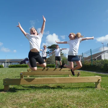 Timber wooden agility balance beams play equipment in a playground setting for children