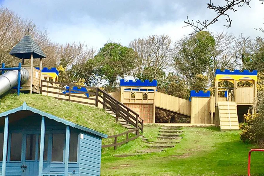 Wooden castle playground climbing frame