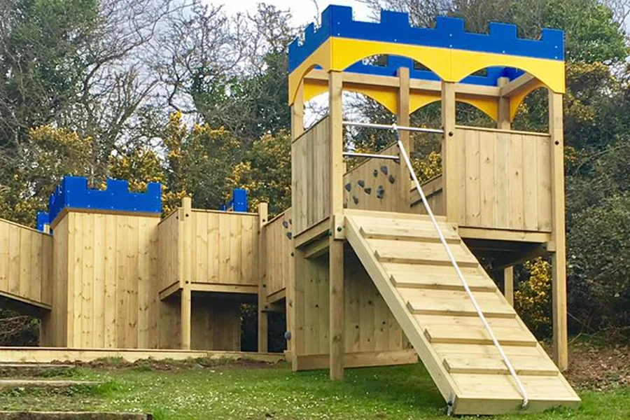 Timber wooden castle climbing frame play equipment in a school playground