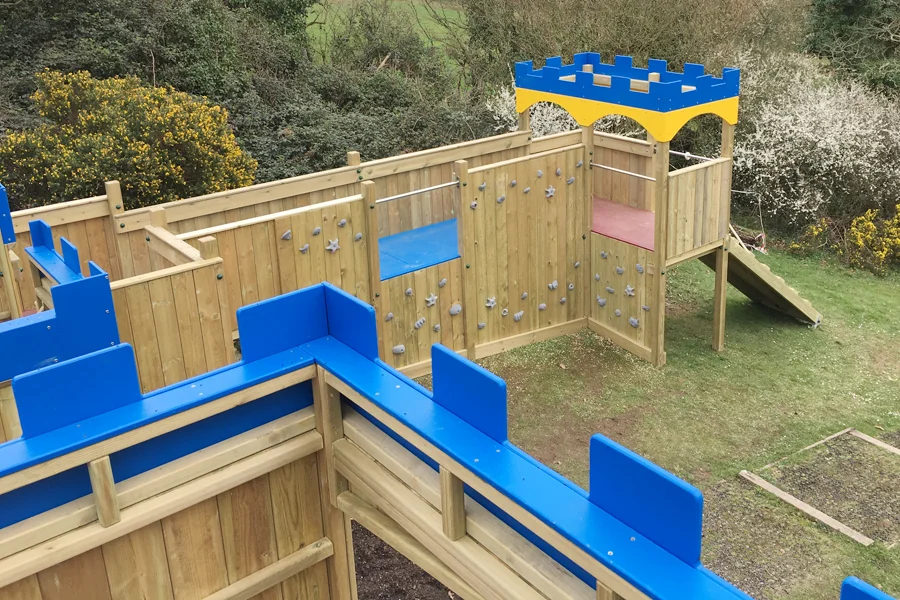 Timber wooden castle climbing frame play equipment in a school playground