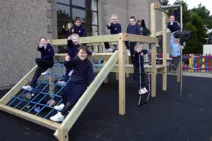 Timber outdoor play equipment at Torpoint Activity Centre featuring wooden climbing frames and playground structures
